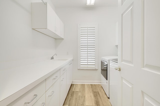 2000 SW Oakwater Pt, Palm City, FL 34990 - laundry area with independent washer and dryer, cabinet space, and light wood-style floors