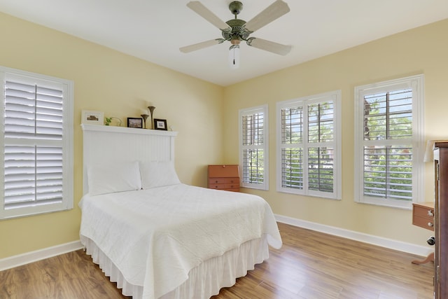 2000 SW Oakwater Pt, Palm City, FL 34990 - bedroom featuring wood finished floors and ceiling fan
