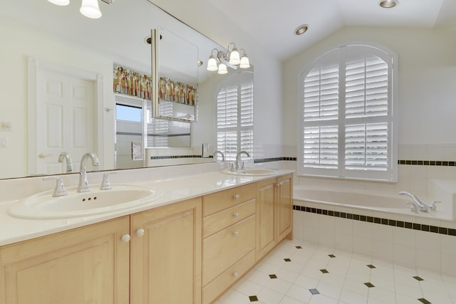 2000 SW Oakwater Pt, Palm City, FL 34990 - full bath with tile patterned floors, a bath, double vanity, and vaulted ceiling