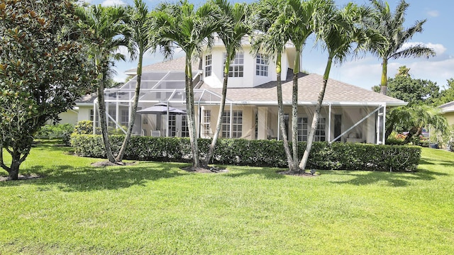 2000 SW Oakwater Pt, Palm City, FL 34990 - rear view of property with a yard, stucco siding, glass enclosure, and a shingled roof