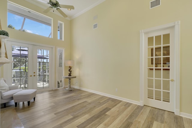 2000 SW Oakwater Pt, Palm City, FL 34990 - living area with french doors, a high ceiling, light wood finished floors, ornamental molding, and ceiling fan