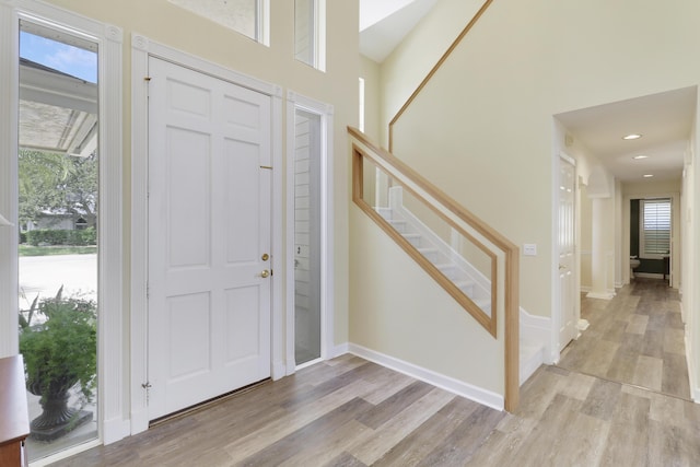 2000 SW Oakwater Pt, Palm City, FL 34990 - foyer entrance featuring light wood-style floors, plenty of natural light, stairway, recessed lighting, and a high ceiling