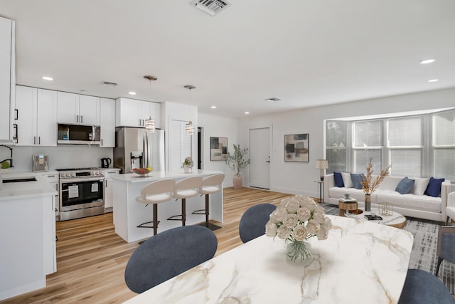 701 37th St, West Palm Beach, FL 33407 - dining area featuring light wood-style floors and recessed lighting
