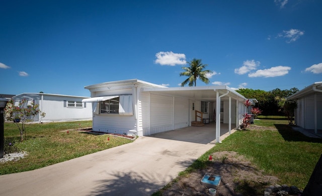 8351 Chisum Trl, Boca Raton, FL 33433 - view of property exterior featuring a yard, driveway, and a carport