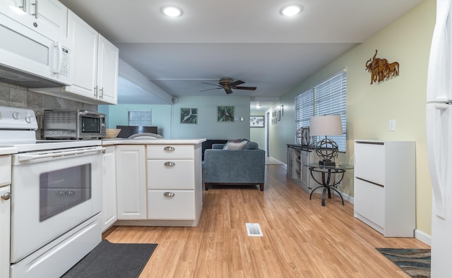 8351 Chisum Trl, Boca Raton, FL 33433 - kitchen with white appliances, a ceiling fan, a peninsula, light wood-style flooring, and white cabinetry