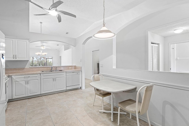 9331 Bridgeport Dr, Royal Palm Beach, FL 33411 - kitchen featuring a ceiling fan, dishwasher, a textured ceiling, arched walkways, and lofted ceiling