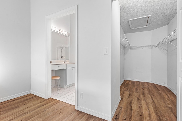 9331 Bridgeport Dr, Royal Palm Beach, FL 33411 - spacious closet featuring wood finished floors and attic access