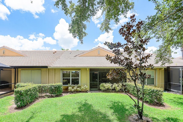 9331 Bridgeport Dr, Royal Palm Beach, FL 33411 - rear view of house featuring a tiled roof, a lawn, and board and batten siding