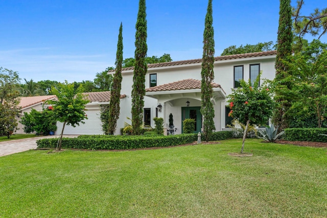 6204 Celadon Cir, Palm Beach Gardens, FL 33418 - mediterranean / spanish-style house featuring a tiled roof, stucco siding, a front lawn, an attached garage, and driveway