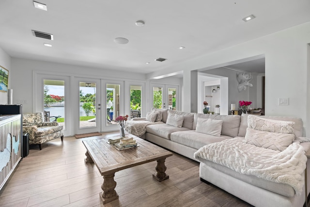 6204 Celadon Cir, Palm Beach Gardens, FL 33418 - living room featuring plenty of natural light, a water view, and light wood-type flooring