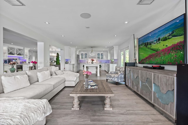 6204 Celadon Cir, Palm Beach Gardens, FL 33418 - living area with recessed lighting, beverage cooler, bar, and light wood-style floors