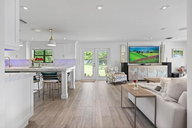 6204 Celadon Cir, Palm Beach Gardens, FL 33418 - living area featuring light wood finished floors, plenty of natural light, and recessed lighting