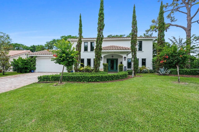 6204 Celadon Cir, Palm Beach Gardens, FL 33418 - mediterranean / spanish house with a tile roof, a front yard, stucco siding, driveway, and an attached garage
