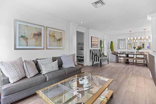 6204 Celadon Cir, Palm Beach Gardens, FL 33418 - living area with a chandelier, wood finished floors, ornamental molding, and recessed lighting