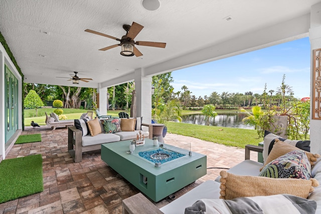 6204 Celadon Cir, Palm Beach Gardens, FL 33418 - view of patio with an outdoor living space with a fire pit, a water view, and a ceiling fan