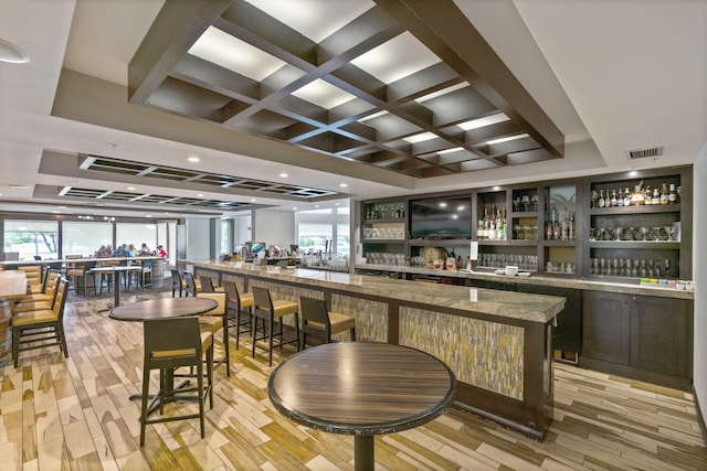 6204 Celadon Cir, Palm Beach Gardens, FL 33418 - indoor wet bar featuring light wood-type flooring, coffered ceiling, and beam ceiling