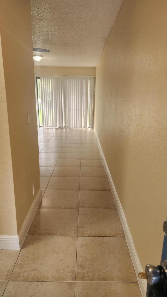 1600 Balfour Point B Dr Unit B, West Palm Beach, FL 33411 - hallway featuring a textured ceiling and tile patterned floors