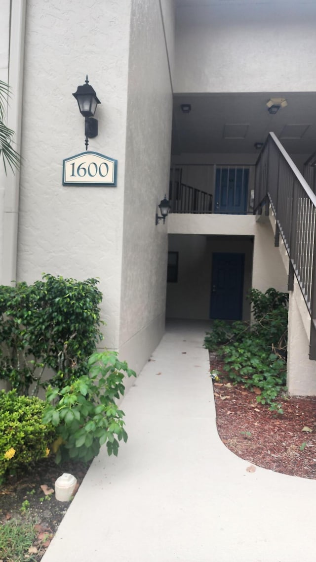 1600 Balfour Point B Dr Unit B, West Palm Beach, FL 33411 - property entrance with stucco siding and a balcony