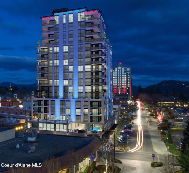 property at twilight with a view of city lights