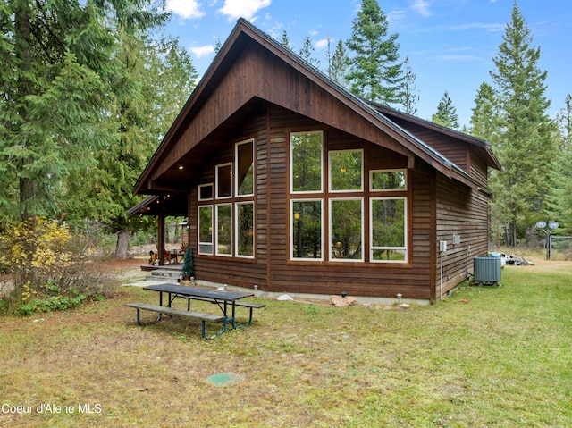 view of home's exterior featuring a lawn and central AC unit