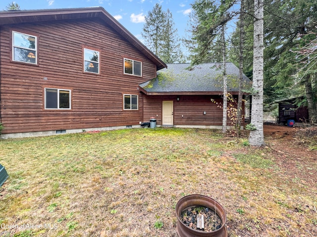 rear view of house with a lawn