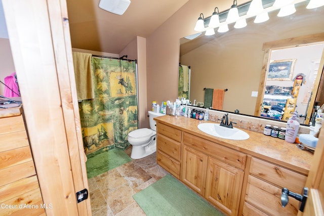 bathroom with toilet, vaulted ceiling, tile floors, and vanity