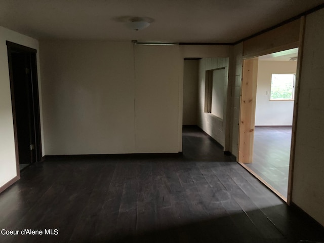 unfurnished room featuring dark wood-type flooring