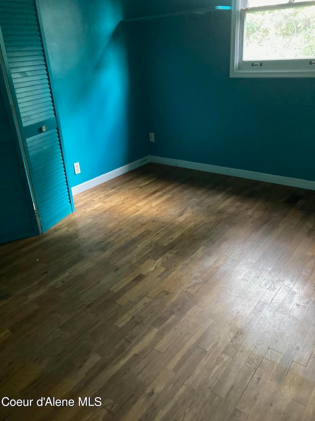 empty room featuring dark hardwood / wood-style flooring