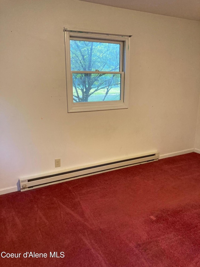 empty room featuring carpet and baseboard heating