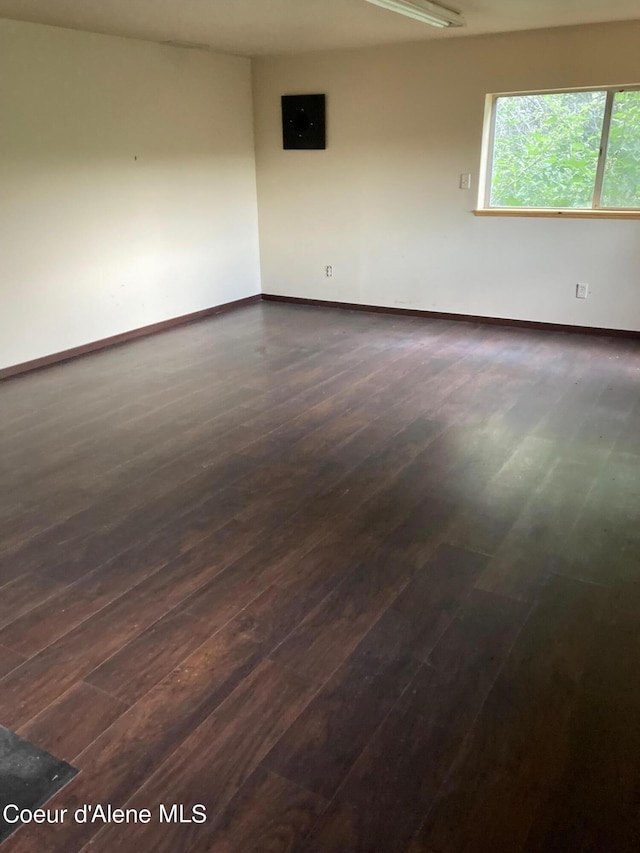 empty room featuring dark wood-type flooring