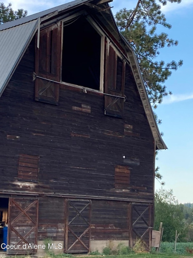 view of property exterior with an outdoor structure