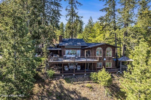 2772 W Lutherhaven Rd, Coeur Dalene, ID 83814 - rear view of property with a deck and a chimney
