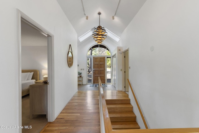 2772 W Lutherhaven Rd, Coeur Dalene, ID 83814 - entryway with rail lighting, light wood-type flooring, and high vaulted ceiling