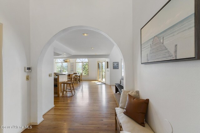 2772 W Lutherhaven Rd, Coeur Dalene, ID 83814 - hall featuring wood finished floors, baseboards, and arched walkways