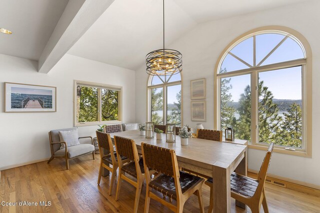 2772 W Lutherhaven Rd, Coeur Dalene, ID 83814 - dining space featuring a chandelier, lofted ceiling, baseboards, and light wood finished floors