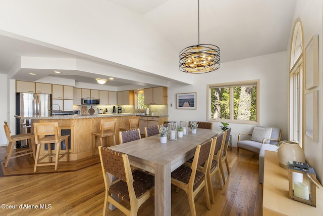 2772 W Lutherhaven Rd, Coeur Dalene, ID 83814 - dining space featuring light wood finished floors, plenty of natural light, and a chandelier