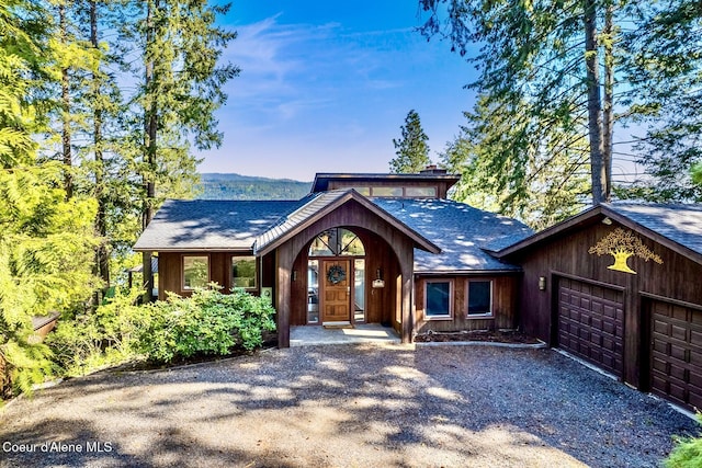 2772 W Lutherhaven Rd, Coeur Dalene, ID 83814 - rustic home featuring driveway, roof with shingles, and a garage