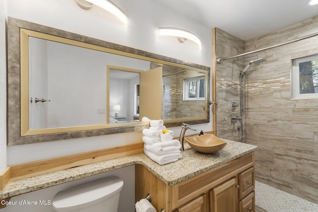 2772 W Lutherhaven Rd, Coeur Dalene, ID 83814 - bathroom with vanity, toilet, and a tile shower