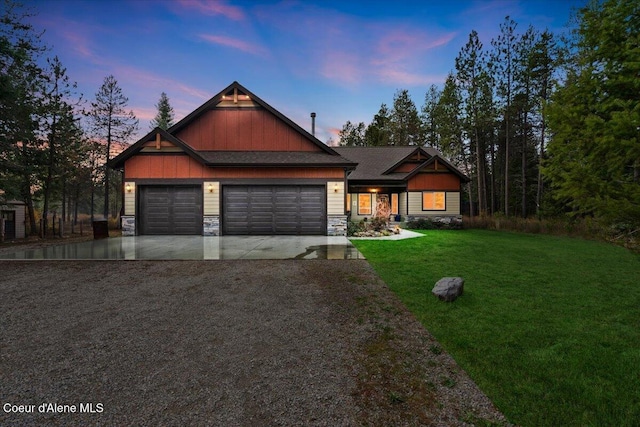 craftsman-style house featuring a lawn and a garage