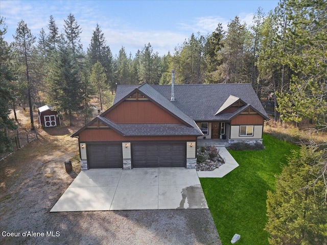 craftsman-style house featuring a storage unit, a garage, and a front lawn