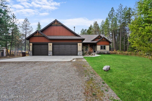 craftsman inspired home featuring a garage and a front lawn