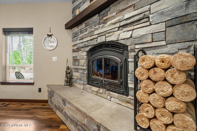 details with a stone fireplace and hardwood / wood-style floors