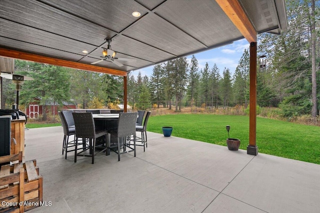 view of patio / terrace featuring ceiling fan and a storage unit