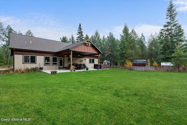 rear view of property with a yard and a patio