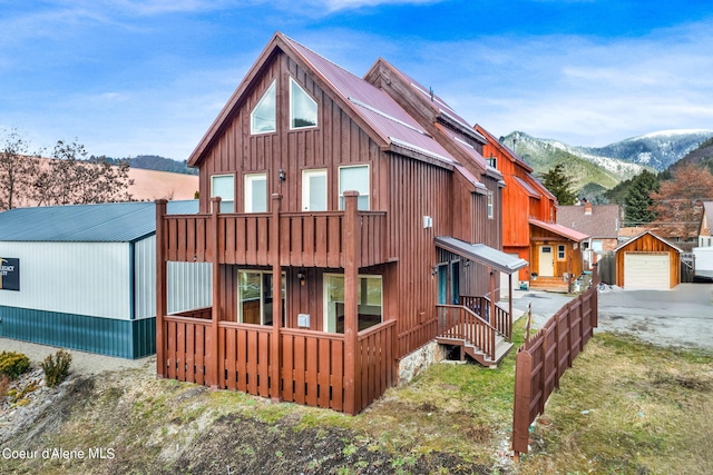 view of front of house with a mountain view, an outdoor structure, and a garage