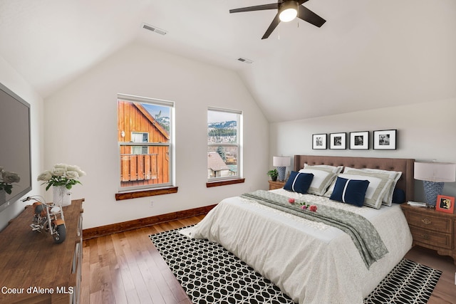 bedroom featuring wood-type flooring, ceiling fan, and vaulted ceiling