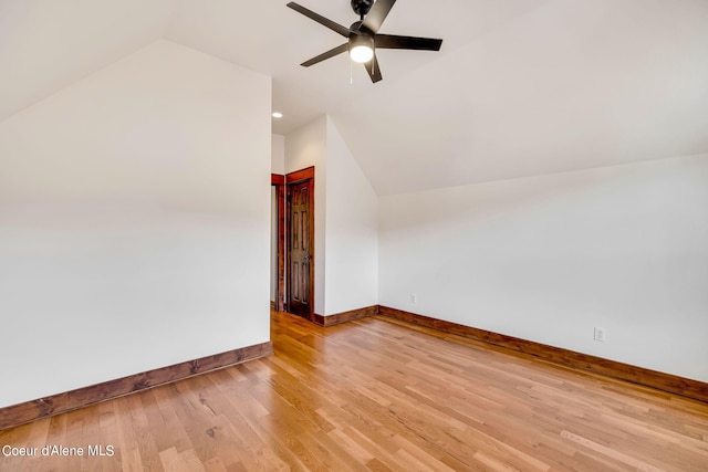 additional living space featuring lofted ceiling, ceiling fan, and light wood-type flooring