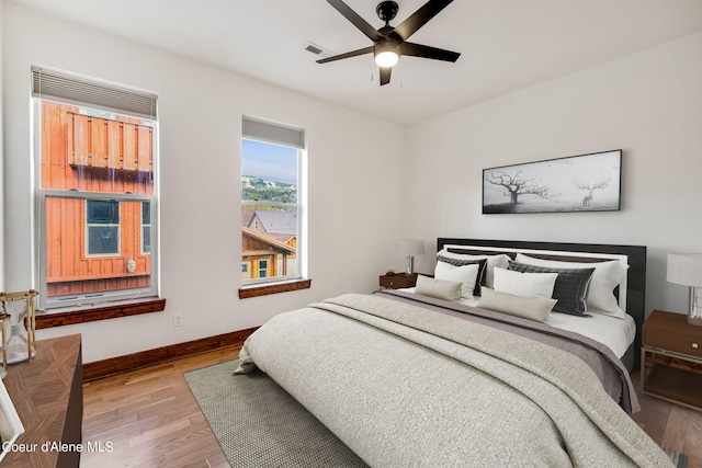 bedroom with ceiling fan and light wood-type flooring