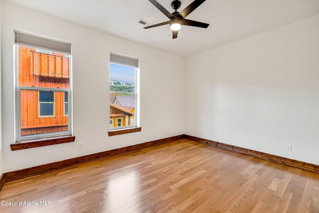 spare room with ceiling fan and light wood-type flooring