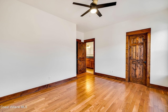 unfurnished bedroom with ensuite bathroom, light hardwood / wood-style floors, and ceiling fan